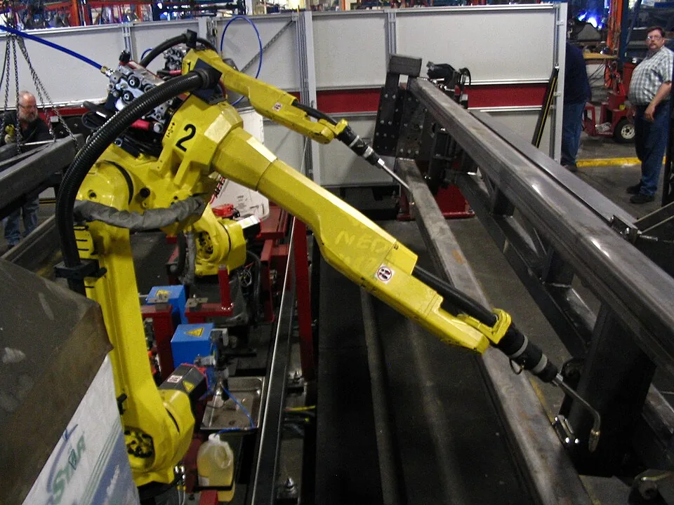 Industrial robot arm working on a metal fabrication line