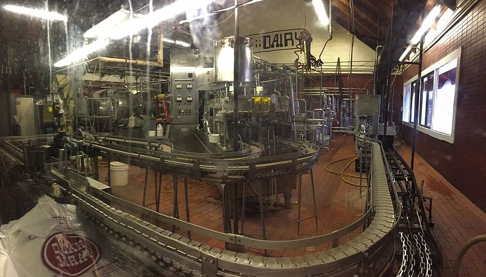 Automated packaging and filling machinery on an FMCG production line