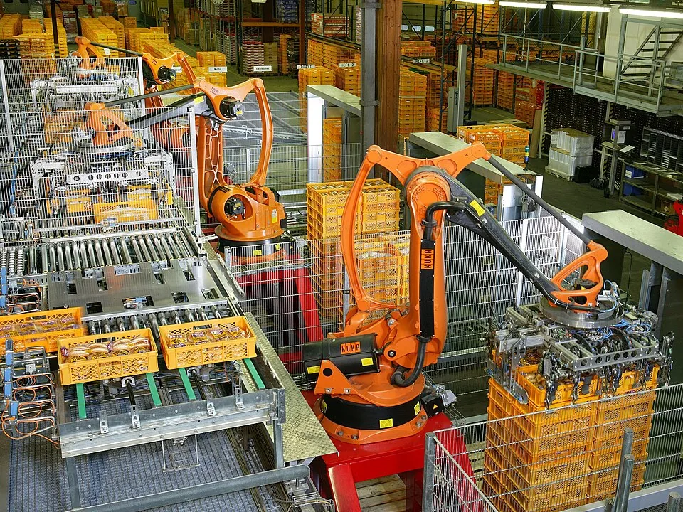 Industrial robots palletizing crates in a warehouse